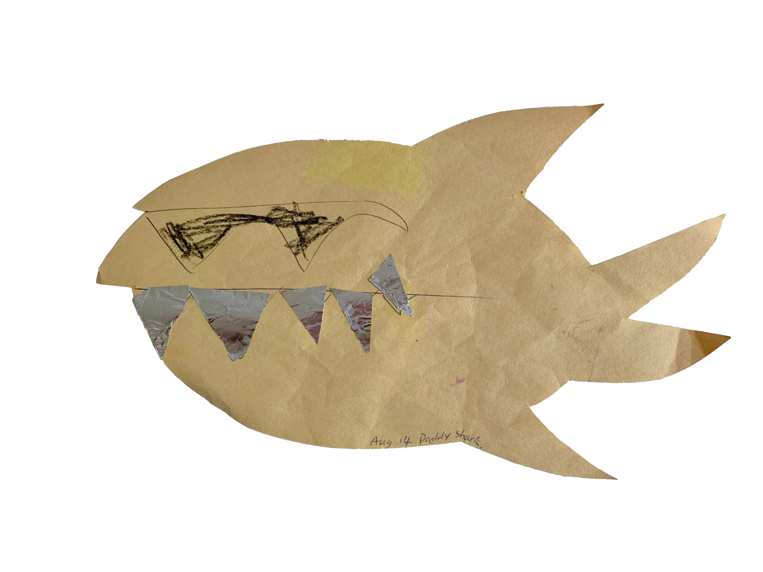 A child's craft project representing 'Daddy Shark' from the popular song, featuring a yellow construction paper shark with crudely drawn black sunglasses and jagged silver teeth.